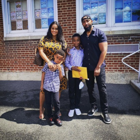 On the right side of the photo, Mysonne is wearing a black shirt and pants, and on the middle is his son jam rock and Keston. And on the left side of the photo is Angelic.